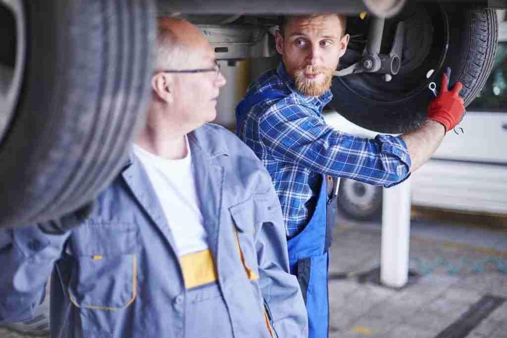 Mechanics changing car wheel at Jackson's Tyres based in Broomhill Glasgow